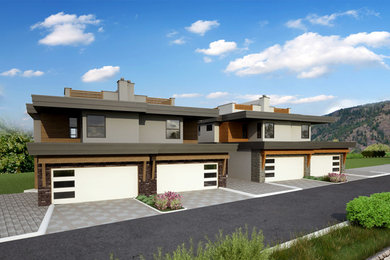 Example of a minimalist gray two-story stucco flat roof design in Vancouver