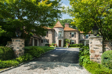 Large traditional beige three-story stone exterior home idea in Philadelphia with a hip roof