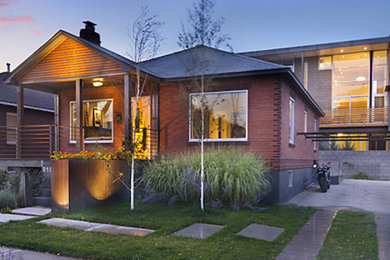 Inspiration for a contemporary brown two-story exterior home remodel in Other