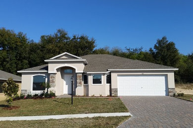 Medium sized and beige classic bungalow house exterior in Orlando with wood cladding.