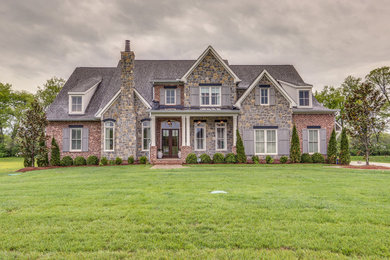 Example of a transitional red two-story brick house exterior design in Nashville