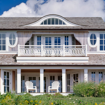 Example of a huge beach style gray two-story wood house exterior design in Boston with a shingle roof