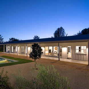 Country white one-story wood gable roof idea in San Francisco