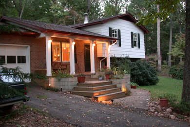 Example of a small eclectic white split-level concrete fiberboard exterior home design in Other
