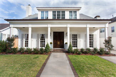 Large transitional white two-story exterior home idea in New Orleans with a gambrel roof
