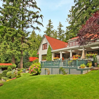 Inspiration for a large cottage beige two-story wood exterior home remodel in Seattle