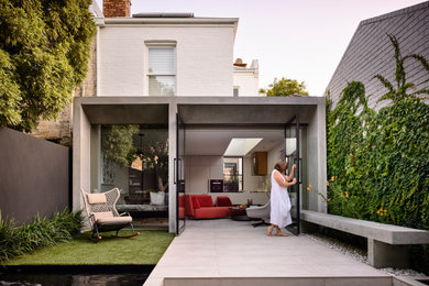 Inspiration for a white contemporary two floor concrete detached house in Melbourne with a flat roof.