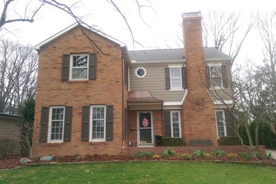 Example of a large classic green two-story concrete fiberboard gable roof design in Columbus
