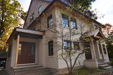 Large craftsman beige three-story stucco gable roof idea in Toronto