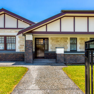This is an example of an expansive arts and crafts one-storey multi-coloured house exterior in Adelaide with a metal roof, mixed siding and a gable roof.