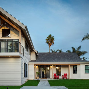 Contemporary white two-story exterior home idea in San Diego with a shingle roof