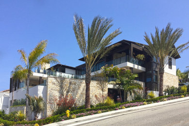 Inspiration for a huge contemporary white three-story wood exterior home remodel with a metal roof