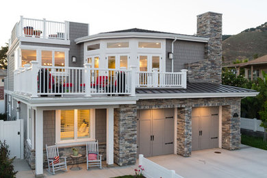 Large coastal gray two-story mixed siding house exterior idea in San Luis Obispo with a hip roof and a metal roof