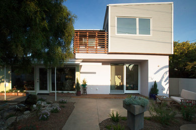 Inspiration for a medium sized and multi-coloured contemporary two floor house exterior in Los Angeles with mixed cladding and a lean-to roof.