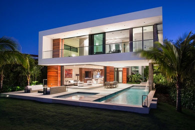 Inspiration for a multi-coloured beach style two floor detached house in Miami with mixed cladding and a flat roof.