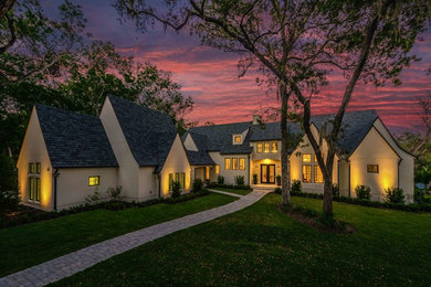 Inspiration for a mid-sized transitional white two-story stucco exterior home remodel in Jacksonville with a shingle roof
