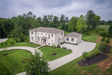 Large transitional beige two-story brick house exterior photo in Louisville with a shingle roof