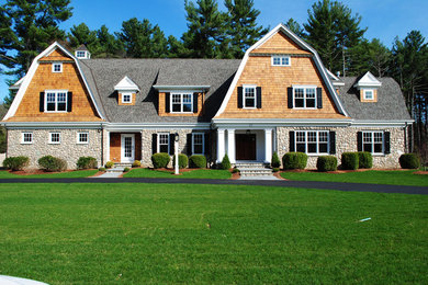 Huge elegant multicolored three-story mixed siding house exterior photo in Boston with a gambrel roof and a shingle roof