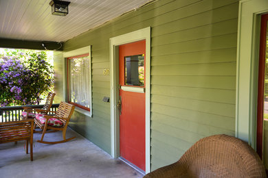 Inspiration for a medium sized and green two floor house exterior in Portland with vinyl cladding.