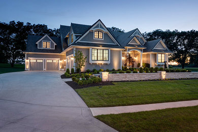 Inspiration for a huge timeless gray two-story concrete fiberboard exterior home remodel in Kansas City with a tile roof