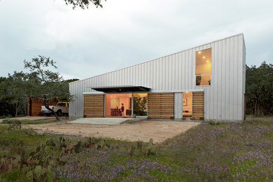 Example of a trendy two-story metal exterior home design in Austin