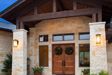 Inspiration for a rural house exterior in Austin with stone cladding.