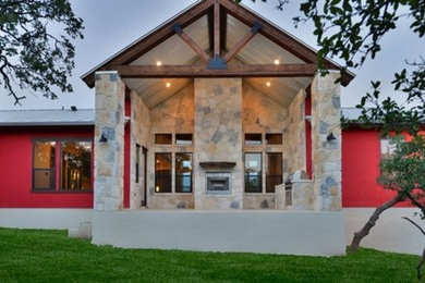 Inspiration for a mid-sized contemporary red one-story mixed siding gable roof remodel in Austin