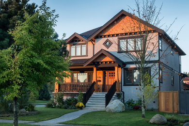 Large craftsman gray two-story stucco exterior home idea in Vancouver