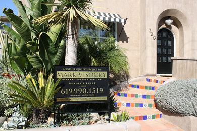 Photo of a medium sized and beige mediterranean bungalow render house exterior in San Diego.