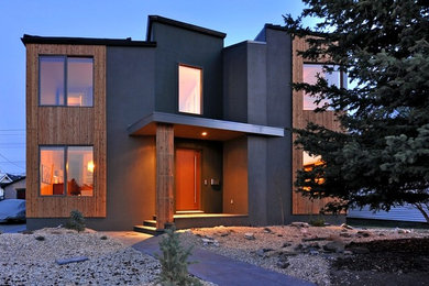 Inspiration for a mid-sized modern gray two-story stucco exterior home remodel in Calgary