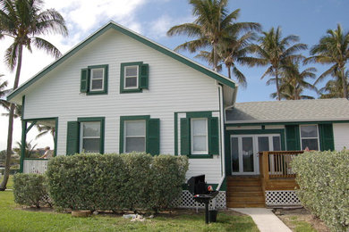Example of a large white two-story exterior home design in Miami