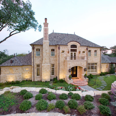 Traditional two-story stone exterior home idea in Dallas