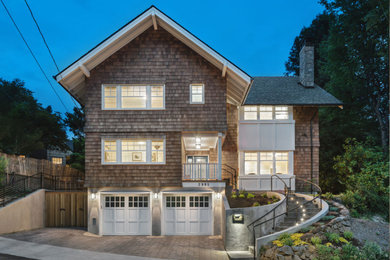 Large craftsman three-story wood exterior home idea in Portland with a shingle roof