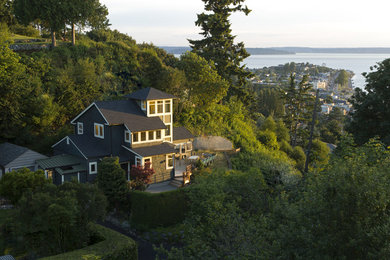 Photo of a large and gey contemporary detached house in Seattle with three floors, wood cladding, a pitched roof and a shingle roof.