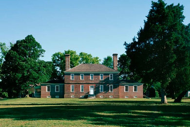 Example of a mid-sized classic brown two-story brick exterior home design in Richmond