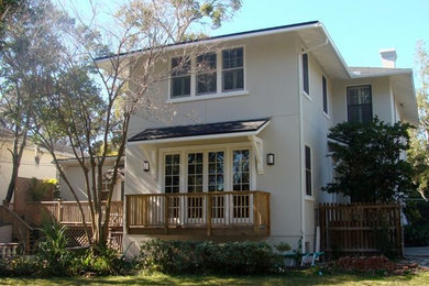 Medium sized and beige classic two floor render house exterior in Jacksonville.
