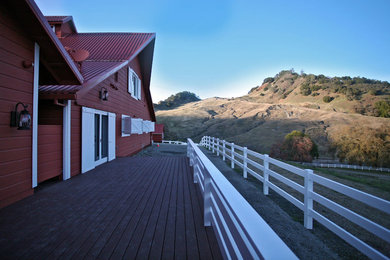 Huge country red two-story wood exterior home idea in San Francisco with a clipped gable roof