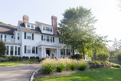 Large beach style white three-story mixed siding house exterior photo in New York with a hip roof and a shingle roof