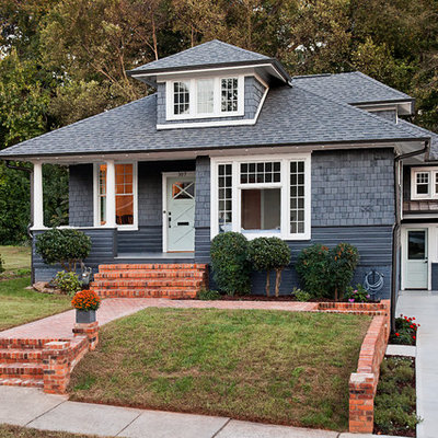 Mid-sized traditional gray two-story mixed siding house exterior idea in Charlotte with a hip roof and a shingle roof