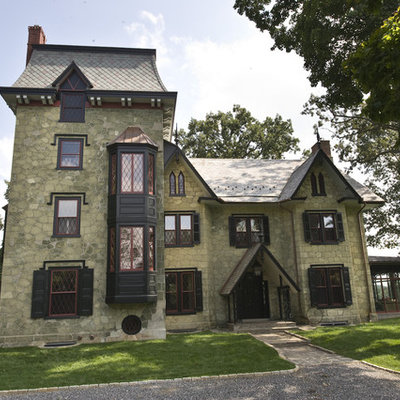 Huge victorian green three-story stone exterior home idea in Philadelphia