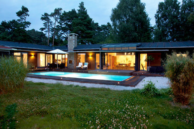 Black modern bungalow detached house in Malmo with wood cladding and shiplap cladding.