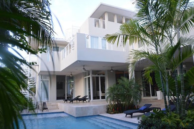 Inspiration for a white three-story exterior home remodel in Miami