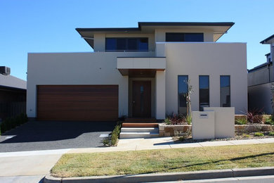 Photo of a large and beige modern two floor house exterior in Canberra - Queanbeyan.