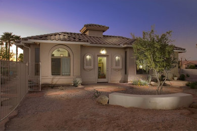 Inspiration for a large and beige mediterranean bungalow render house exterior in Phoenix.