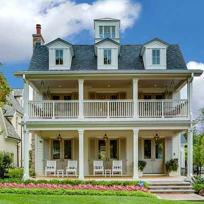 Traditional white three-story house exterior idea in Chicago with a shingle roof