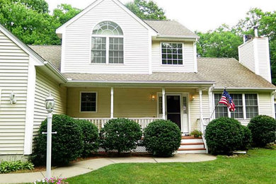 Example of a mid-sized classic beige two-story vinyl exterior home design in Providence