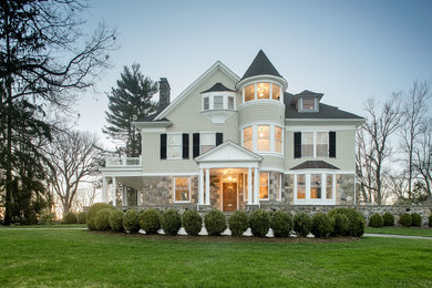Example of a classic beige three-story mixed siding exterior home design in New York