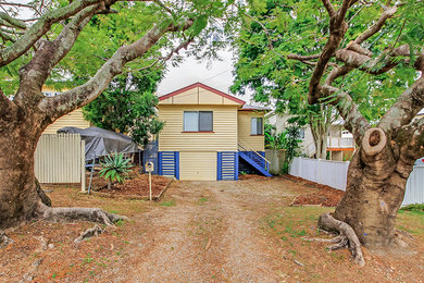 Medium sized classic two floor detached house in Brisbane with wood cladding, a pitched roof and a metal roof.
