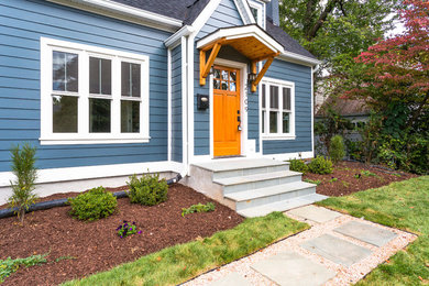 This is an example of a medium sized and blue traditional two floor detached house in DC Metro with wood cladding, a pitched roof and a shingle roof.