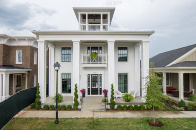 Inspiration for a large and white traditional two floor brick house exterior in Louisville with a flat roof.